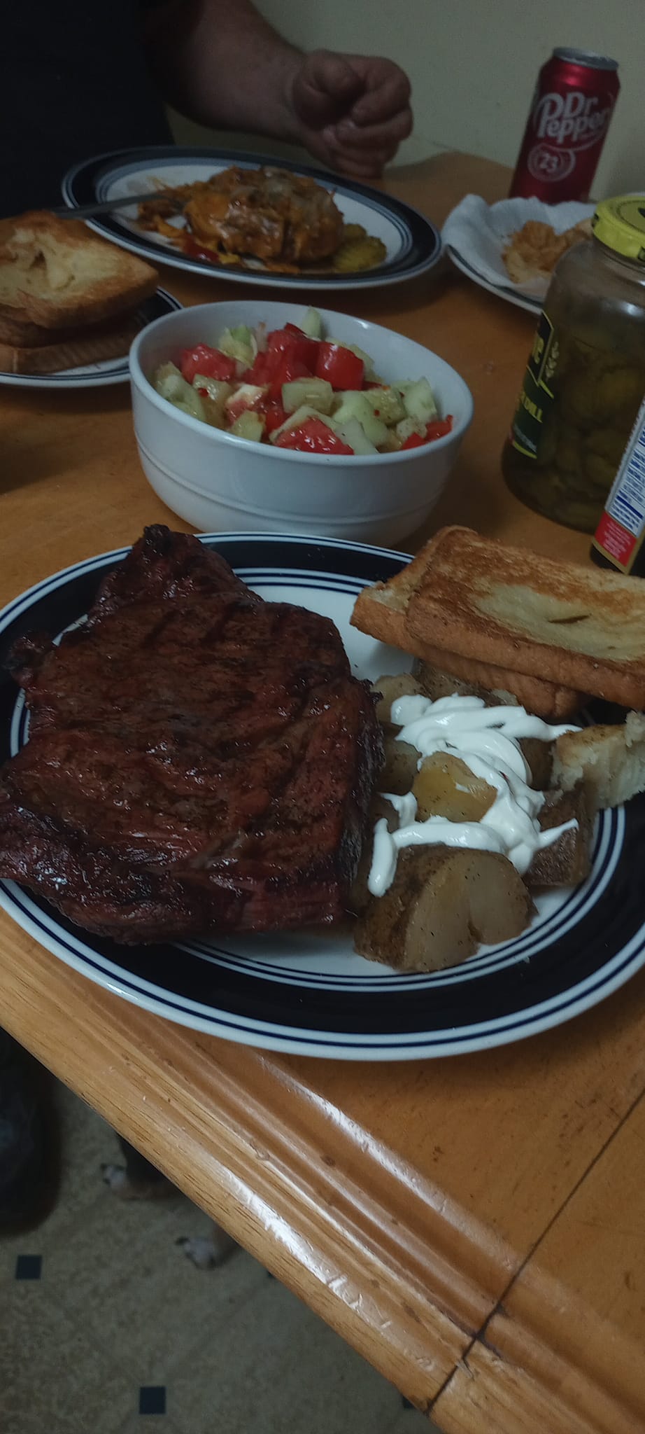 Ribeye steak, potatoes with sour cream, salad, garlic toast