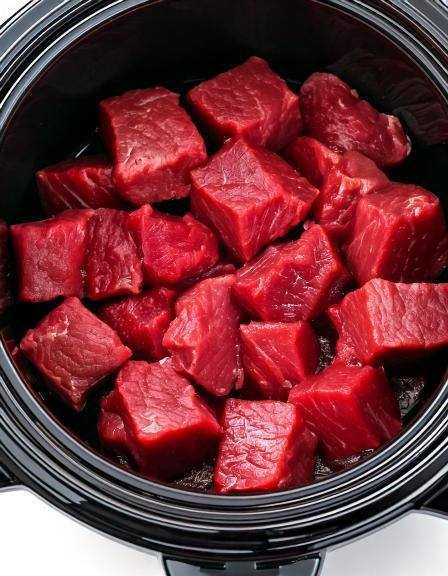 Put raw cubed beef in a slow cooker with these 3 ingredients. You won’t believe how good it tastes.